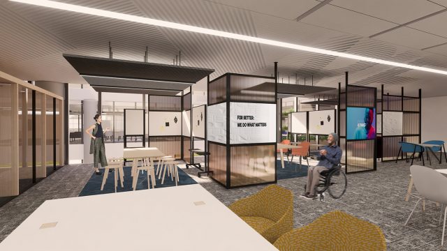 Office space showing person in a wheelchair with space around them to move between desks and shelving areas